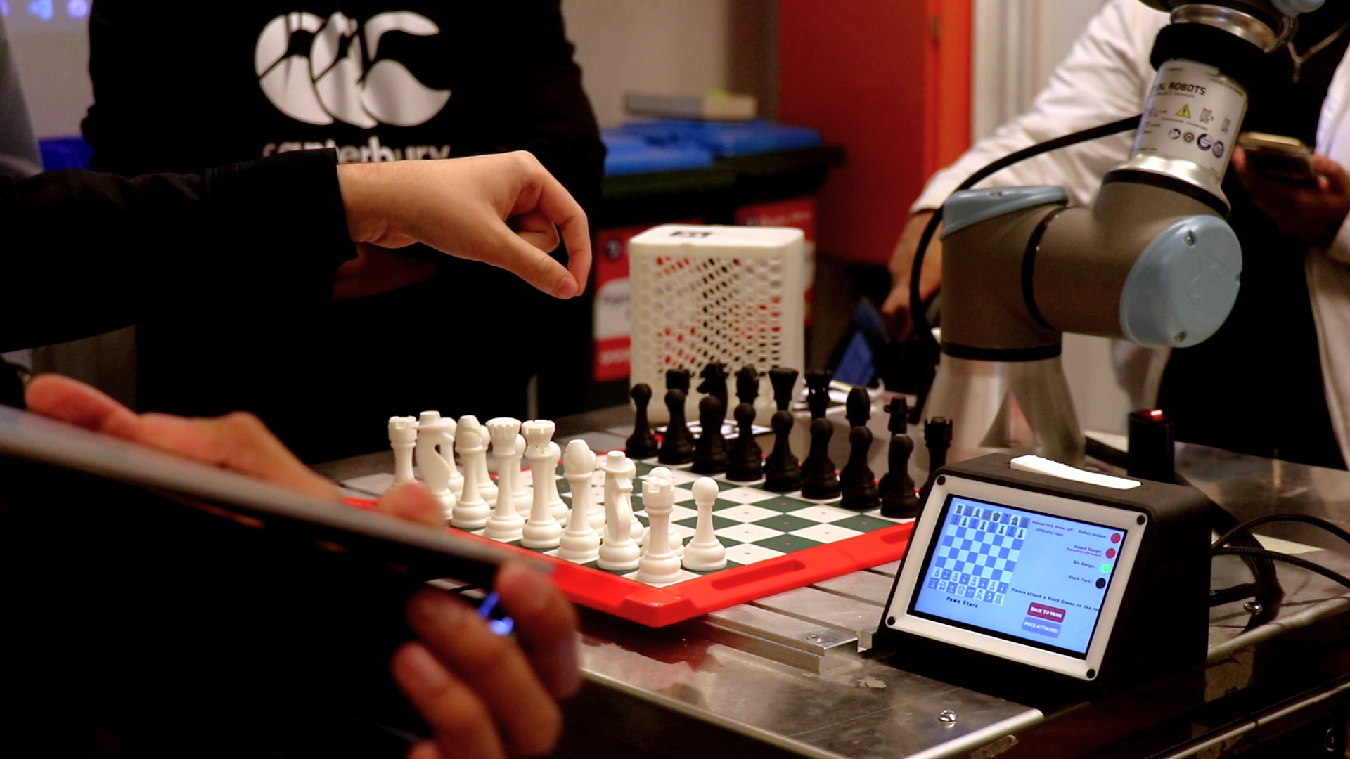 Player making a move against the chess cobot